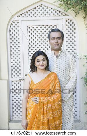 Portrait of a mid adult couple standing together View Large Photo Image Stock Image - Portrait of a mid adult couple standing together. Fotosearch