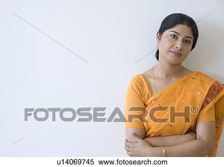 Portrait of a teacher standing with her arms crossed View Large Photo Image Stock Photography - Portrait of a teacher standing with her arms crossed. Fotosearch