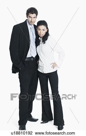 Stock Image - Portrait of a young couple standing together. Fotosearch