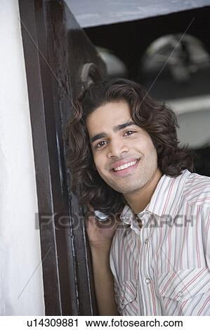 Stock Image - Portrait of a young man smiling. Fotosearch