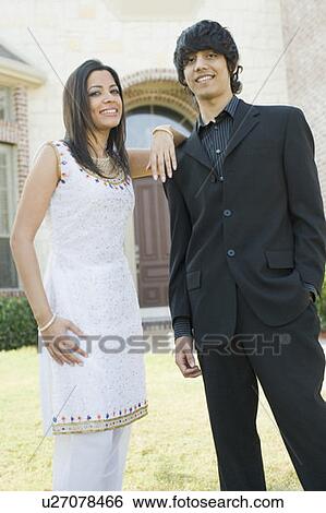Stock Photograph - Portrait of a young woman and her brother smiling. Fotosearch