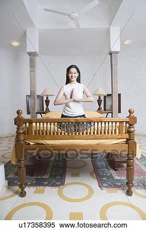 Portrait of a young woman kneeling on the bed in a prayer position View Large Photo Image Stock Photography - Portrait of a young woman kneeling on the bed in a prayer position. Fotosearch