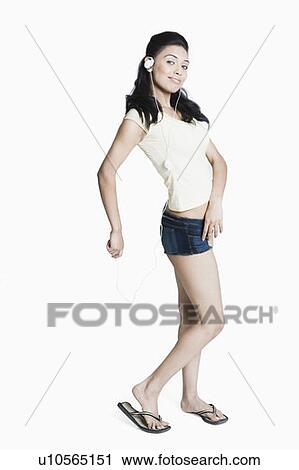 Portrait of a young woman listening to an MP3 player View Large Photo Image Stock Image - Portrait of a young woman listening to an MP3 player. Fotosearch