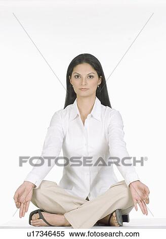Stock Photography - Portrait of a young woman sitting in the lotus position. Fotosearch