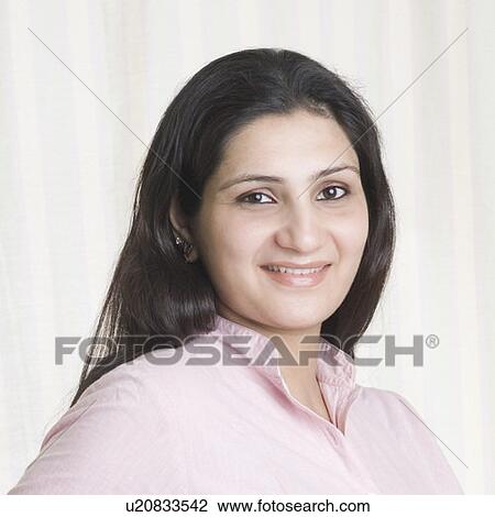 Stock Image - Portrait of a young woman smiling. Fotosearch