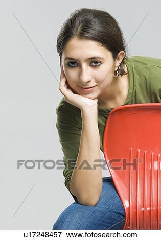 Portrait of a young woman smiling View Large Photo Image Stock Photo - Portrait of a young woman smiling. Fotosearch