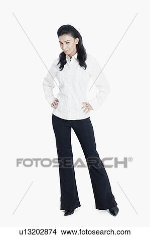Portrait of a young woman standing with arms akimbo View Large Photo Image Picture - Portrait of a young woman standing with arms akimbo. Fotosearch