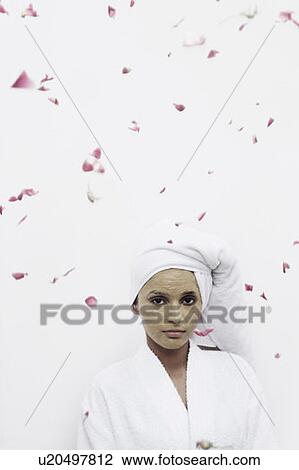 Portrait of a young woman with a facial mask with rose petals falling on her View Large Photo Image Stock Image - Portrait of a young woman with a facial mask with rose petals falling on her. Fotosearch