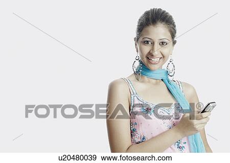 Stock Photo - Portrait of a young woman with a mobile phone smiling. Fotosearch