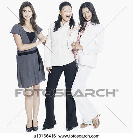 Portrait of three young women standing together and smiling View Large Photo Image Stock Photograph - Portrait of three young women standing together and smiling. Fotosearch