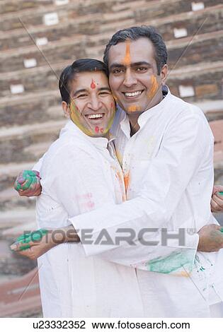 Portrait of two mid adult men hugging each other and smiling View Large Photo Image Stock Image - Portrait of two mid adult men hugging each other and smiling. Fotosearch
