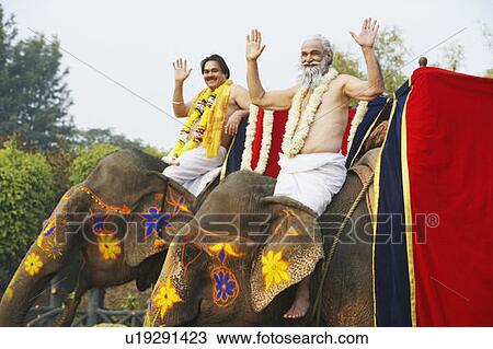 Stock Image - Portrait of two priests riding elephants. Fotosearch
