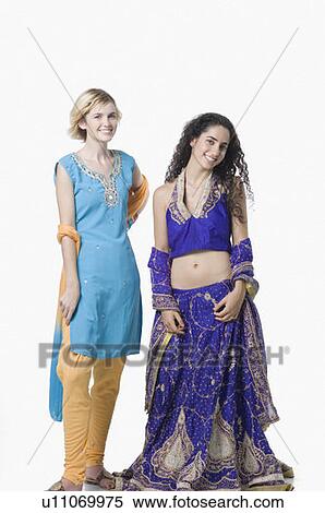 Portrait of two young women standing together in traditional clothing and smiling View Large Photo Image Stock Photography - Portrait of two young women standing together in traditional clothing and smiling. Fotosearch
