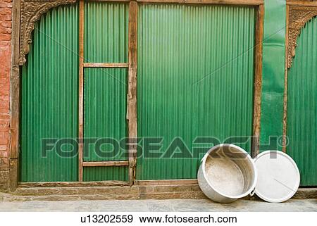 Pot with a lid leaning against a shutter, Lakshmi Narayan Temple complex, Chamba, Himachal Pradesh, India View Large Photo Image Stock Photo - Pot with a lid leaning against a shutter, Lakshmi Narayan Temple complex, Chamba, Himachal Pradesh, India. Fotosearch