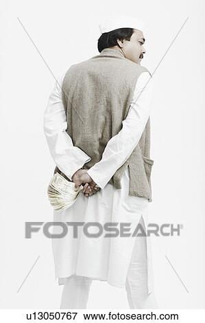 Rear view of a mature man holding Indian currency View Large Photo Image Stock Photo - Rear view of a mature man holding Indian currency. Fotosearch