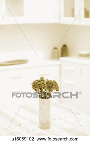 Stock Image - Roses in a vase on the dining table. Fotosearch