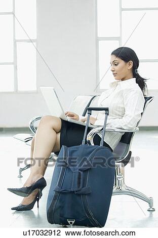 Side profile of a businesswoman sitting and using a laptop View Large Photo Image Stock Image - Side profile of a businesswoman sitting and using a laptop. Fotosearch