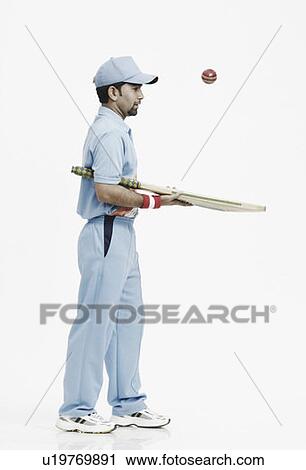 Side profile of a young man playing with a cricket bat and a cricket ball View Large Photo Image Stock Image - Side profile of a young man playing with a cricket bat and a cricket ball. Fotosearch