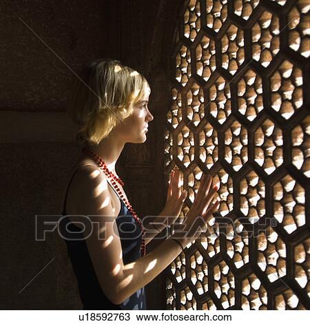 Side profile of a young woman looking through a window, Taj Mahal, Agra, Uttar Pradesh, India View Large Photo Image Stock Image - Side profile of a young woman looking through a window, Taj Mahal, Agra, Uttar Pradesh, India. Fotosearch