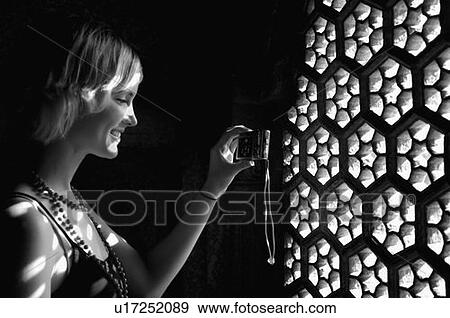 Side profile of a young woman taking a picture through window with a digital camera, Taj Mahal, Agra, Uttar Pradesh, India View Large Photo Image Stock Photo - Side profile of a young woman taking a picture through window with a digital camera, Taj Mahal, Agra, Uttar Pradesh, India. Fotosearch