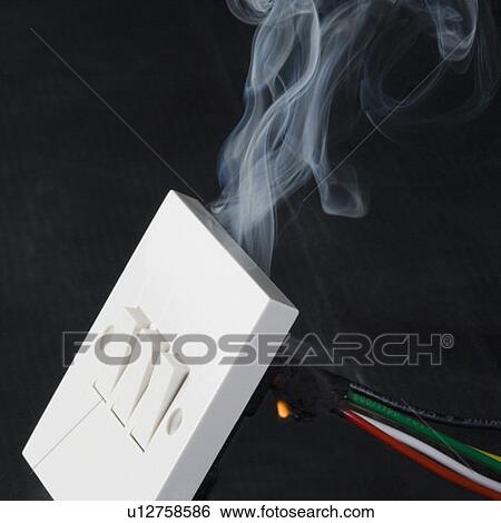 Stock Photograph - Smoke coming out from a switchboard. Fotosearch