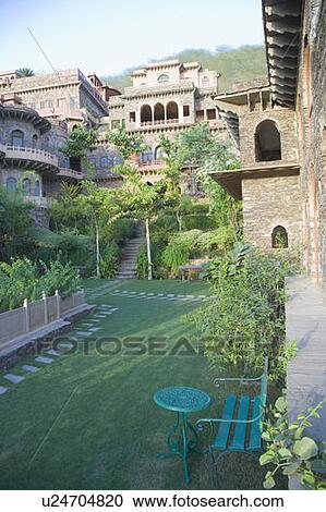 Stock Image - Table and a chair in the courtyard of a fort, Neemrana Fort Palace, Neemrana, Alwar, Rajasthan, India. Fotosearch
