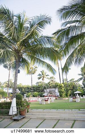 Stock Image - Tables and chairs in a lawn. Fotosearch