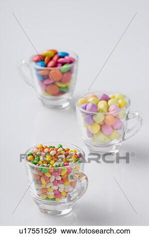 Stock Photo - Three cups filled with jellybeans and candies. Fotosearch