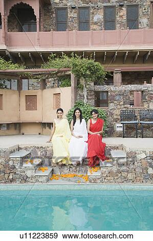 Three young women sitting at the poolside, Neemrana Fort Palace, Neemrana, Alwar, Rajasthan, India View Large Photo Image Stock Photo - Three young women sitting at the poolside, Neemrana Fort Palace, Neemrana, Alwar, Rajasthan, India. Fotosearch
