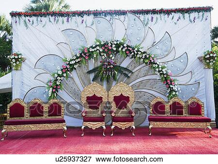 Stock Photo - Two armchairs with couches on a wedding stage. Fotosearch