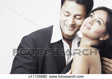 Young man embracing a young woman View Large Photo Image Stock Image - Young man embracing a young woman. Fotosearch