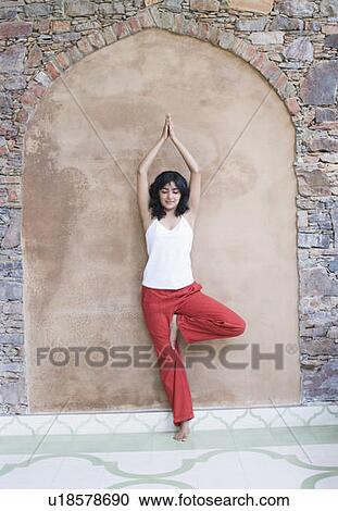 Young woman doing yoga View Large Photo Image Stock Image - Young woman doing yoga. Fotosearch