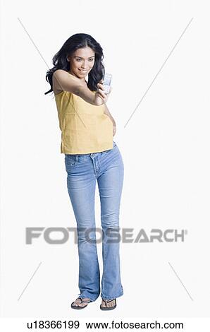 Stock Photo - Young woman taking a photograph of herself with a mobile phone. Fotosearch