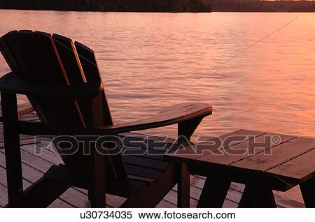 Stock Photography - Empty chair against twilight sky. Fotosearch