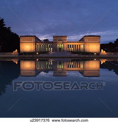 Stock Photograph - Luminated Buildings on Lake. Fotosearch