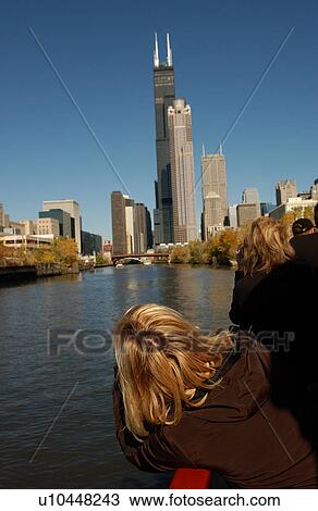 Stock Image - Person looking at high rise buildings in Chicago. Fotosearch