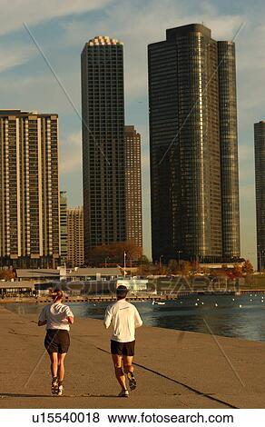 Rear view of a couple jogging by Lakeshore Drive View Large Photo Image Stock Photo - Rear view of a couple jogging by Lakeshore Drive. Fotosearch
