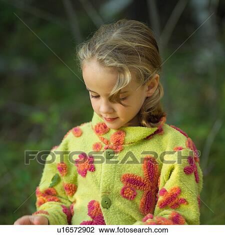Stock Image - 5 - 6 year old girl looking downward. Fotosearch
