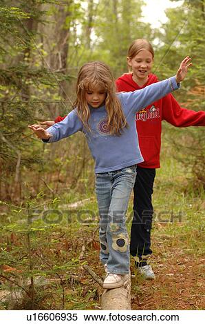Children balancing on a log View Large Photo Image Stock Photography - Children balancing on a log. Fotosearch