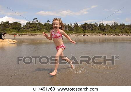 Stock Image - Children on beach, Pacific Rim National Park, Vancouver Island, Canada. Fotosearch
