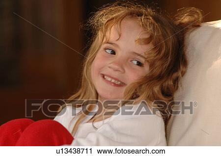 Stock Image - Close up of blond girl’s face. Fotosearch