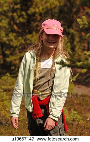 Stock Photo - Girl in pink hat looking at camera, Jasper National Park, Canada. Fotosearch