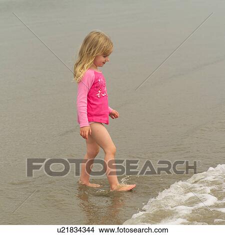 Picture - Girl standing in water on beach, Pacific Rim Park, Vancouver Island, Canada. Fotosearch