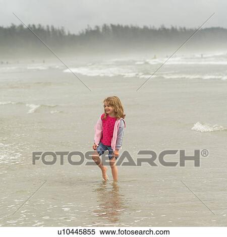 Girl standing towards water on beach, Pacific Rim Park, Vancouver Island, Canada View Large Photo Image Stock Photography - Girl standing towards water on beach, Pacific Rim Park, Vancouver Island, Canada. Fotosearch