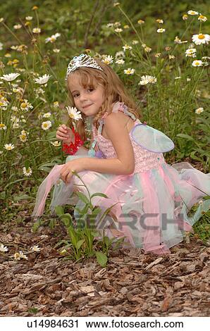 Young girl in fairy costume picking wildflowers View Large Photo Image Stock Image - Young girl in fairy costume picking wildflowers. Fotosearch