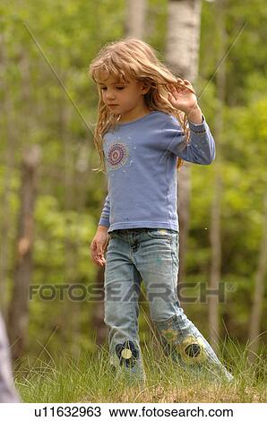 Stock Image - Young girl in the forest. Fotosearch