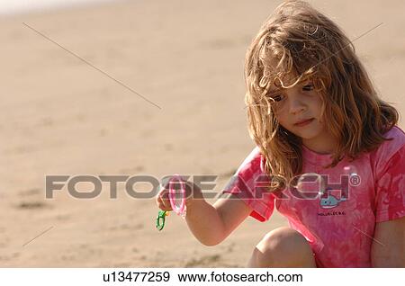 Stock Photo - Young girl making bubbles on beach, Pacific Rim National Park, Vancouver Island, Canada. Fotosearch