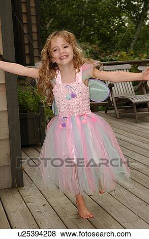 Stock Photo - Young girl smiling wearing a fairy costume. Fotosearch