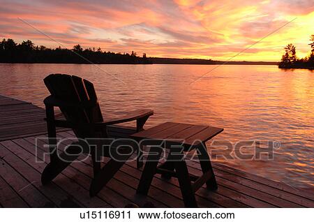 Stock Image - Empty chair against twilight sky. Fotosearch