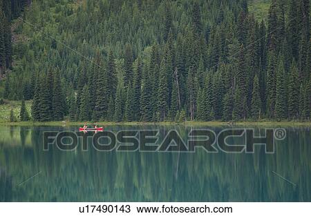People in a canoe on a lake, Rocky Mountains, Canada View Large Photo Image Stock Image - People in a canoe on a lake, Rocky Mountains, Canada. Fotosearch